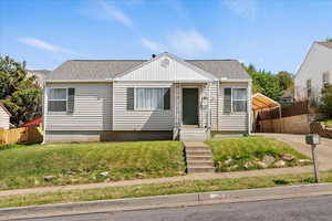 View of front of home featuring a shingled roof