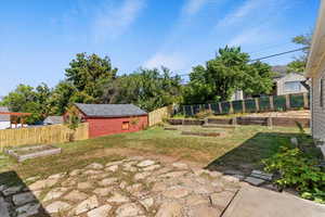 Fenced backyard with a garden and a patio area