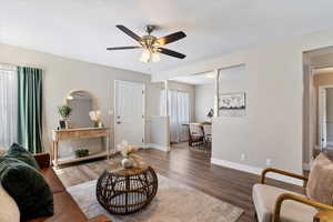 Living area featuring wood finished floors and ceiling fan