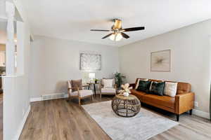 Living room with wood finished floors and ceiling fan