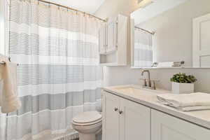 Full bath featuring vanity and toilet