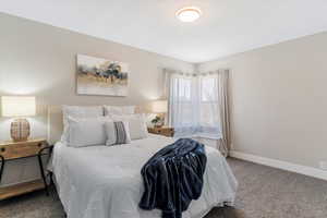 Carpeted bedroom with baseboards