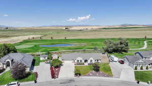 View of rural area with a water and mountain view, and golf course view