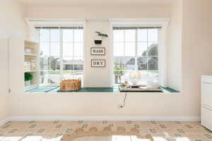 Detailed view of baseboards and washer / clothes dryer off of kitchen