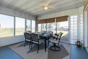 Sunroom featuring outdoor dining space and a ceiling fan