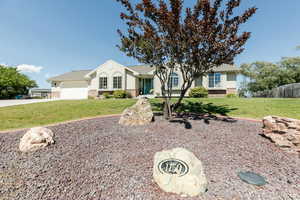 Single story home with driveway, stucco siding, a garage, and stone siding