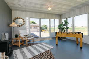 Sunroom / solarium featuring healthy amount of natural light, finished floors