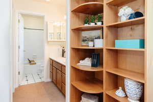 Primary Bathroom featuring bathing tub / shower combination, vanity, and light tile patterned flooring