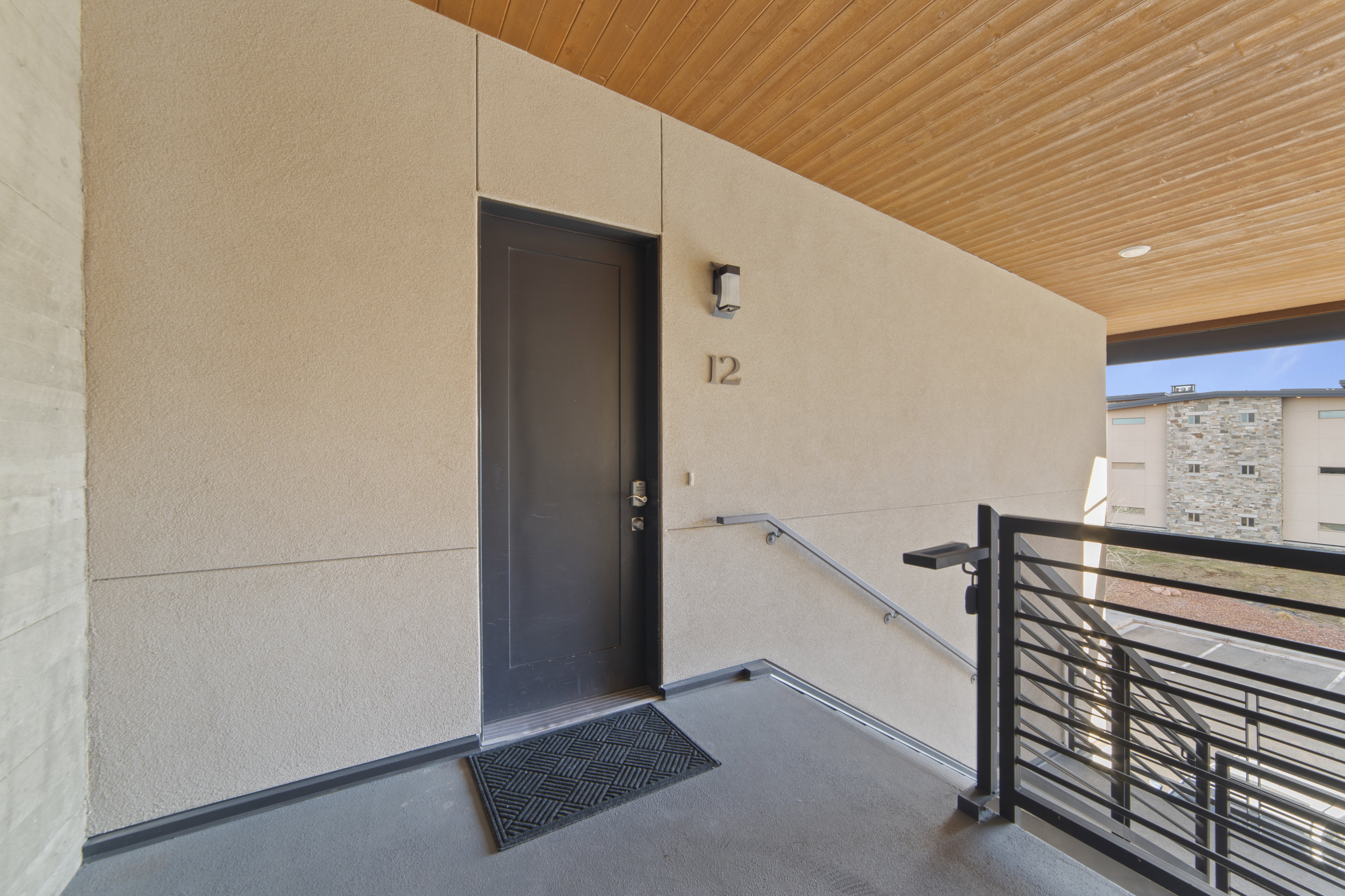 Property entrance with stucco siding