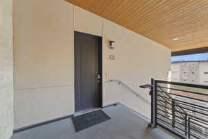 Property entrance with stucco siding