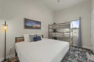 Bedroom featuring ceiling fan and baseboards