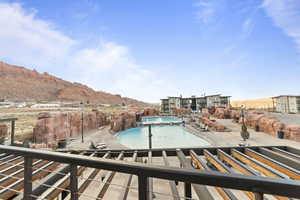 Community pool with a mountain view and a patio area