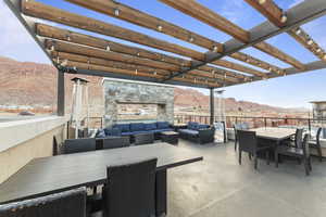 View of patio / terrace with outdoor dining area, a mountain view, and outdoor lounge area