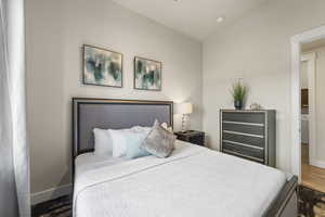 Bedroom featuring wood finished floors, washer / clothes dryer, and wine cooler