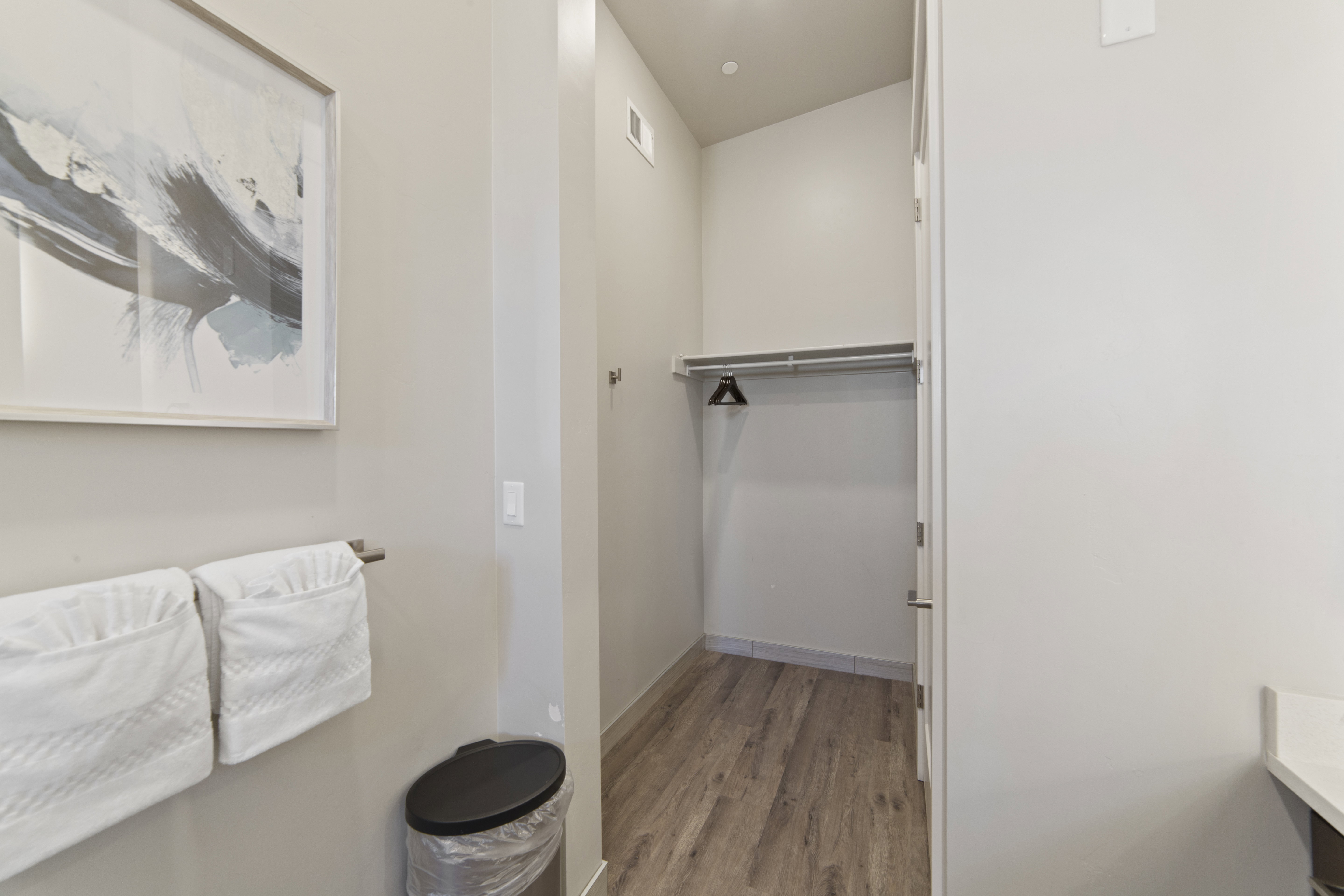 Bathroom with light wood-type flooring and baseboards