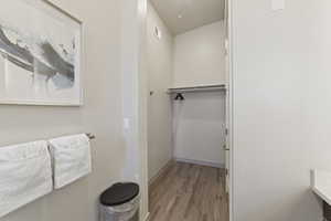 Bathroom with light wood-type flooring and baseboards