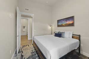 Bedroom with baseboards and wood finished floors