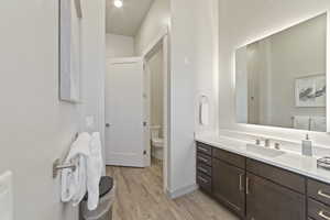 Bathroom with vanity and light wood finished floors