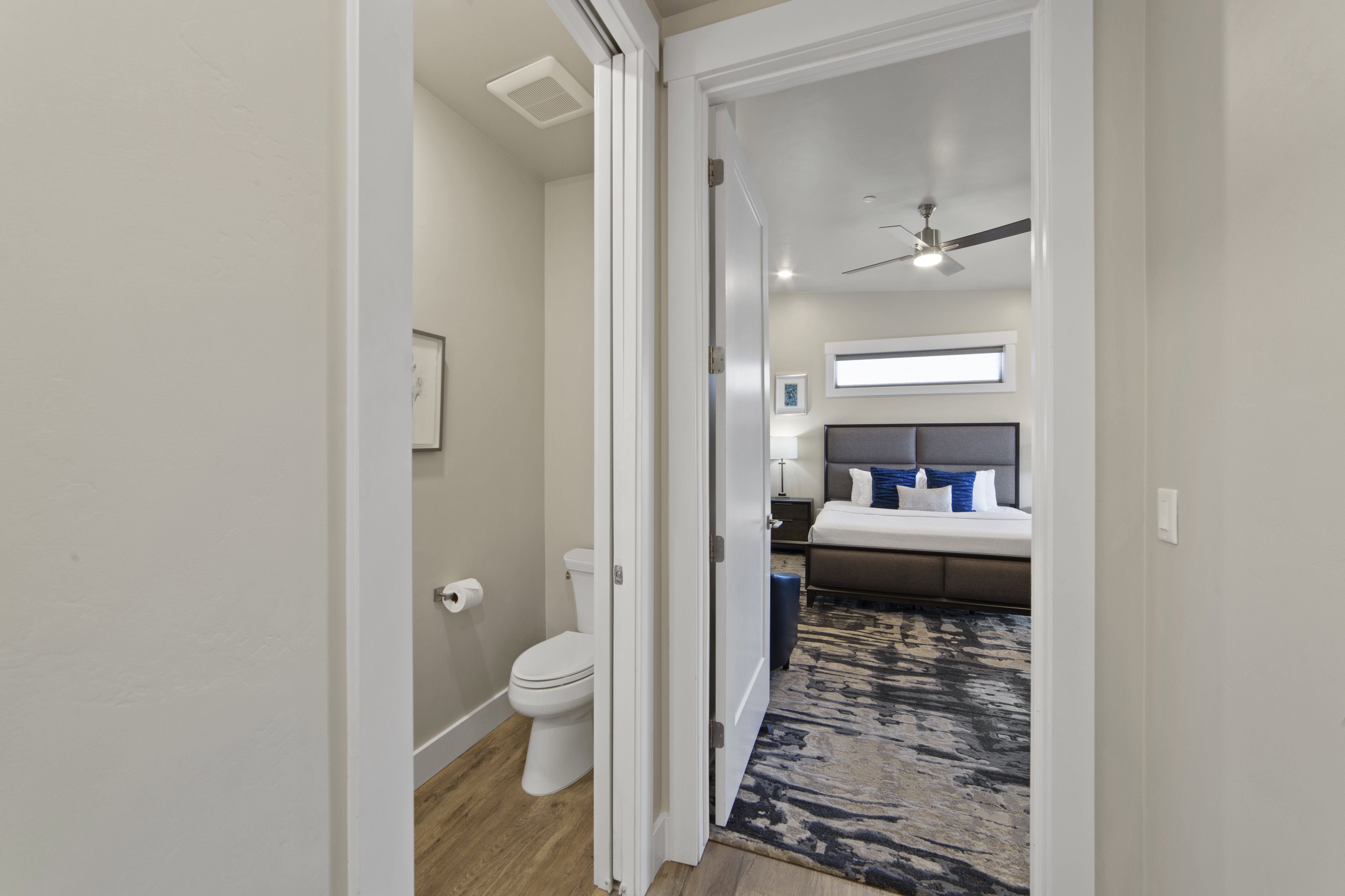 Bathroom with light wood-style floors and a ceiling fan