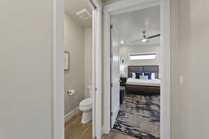 Bathroom with light wood-style floors and a ceiling fan
