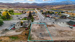 View of property location with a mountainous background and property boundaries highlighted