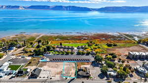 Aerial overview of property's location with property parcel outlined and a water and mountain view