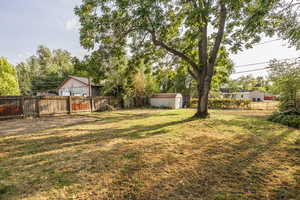 Fenced backyard with a storage unit