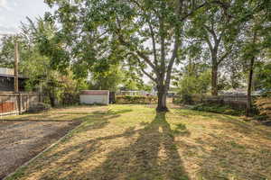Fenced backyard with a storage shed