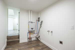 Washroom featuring dark wood-style flooring and washer hookup