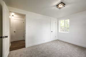 Unfurnished bedroom with carpet floors and a closet