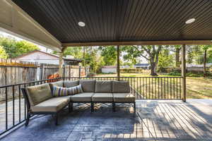 Stamped Concrete patio with a fenced backyard and an outdoor living space