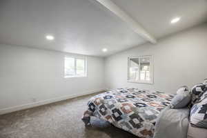 Carpeted bedroom with multiple windows and recessed lighting