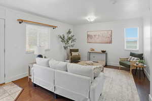 Living area featuring crown molding and wood finished floors