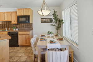 Dining area with ornamental molding and light tile patterned floors