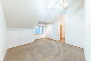 Primary Bedroom with vaulted ceiling, walk-in closet and private vanity.
