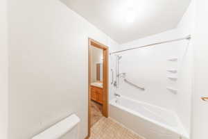 Jack and Jill bathroom with separate vanities. One door to hall, one door into primary bedroom.