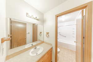 Jack and Jill bathroom with separate vanities. One door to hall, one door into primary bedroom.