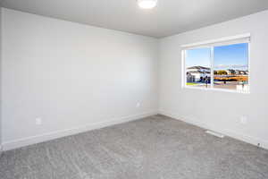 Empty room with baseboards and carpet