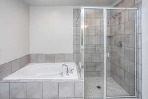 Full bathroom with a garden tub and a shower stall