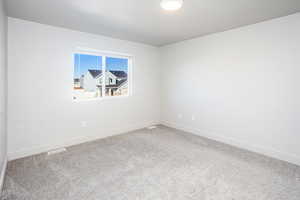 Unfurnished room featuring carpet and baseboards