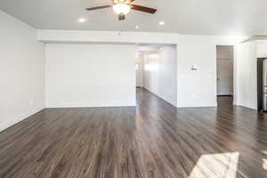 Unfurnished living room featuring dark wood finished floors, recessed lighting, ceiling fan, and a textured ceiling