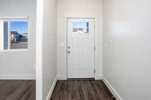 Entryway featuring baseboards and wood finished floors