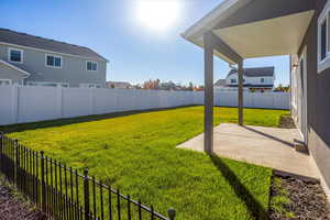 Fenced backyard with a patio and a residential view