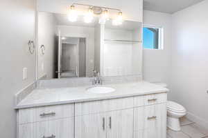 Full bathroom with vanity and light tile patterned floors