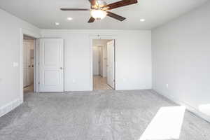 Unfurnished bedroom featuring light colored carpet, recessed lighting, a textured ceiling, and ceiling fan