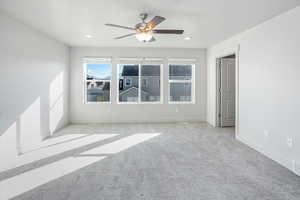 Empty room with carpet flooring, ceiling fan, and recessed lighting