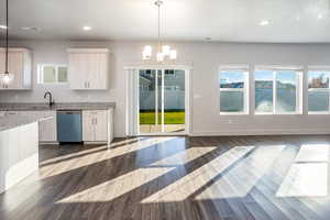 Kitchen featuring dark wood-style floors, a chandelier, dishwasher, plenty of natural light, and recessed lighting