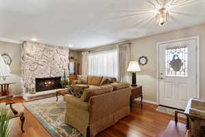 Formal living room with a fireplace, gorgeous laminate floors, and healthy amount of natural light