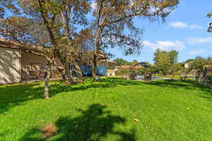 View of yard with a pool and a patio area