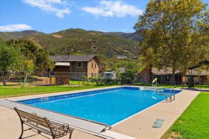 View of swimming pool with a mountain view and a patio area
